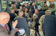 Joseph Scheff, the 405th Army Field Support Brigade deputy to the commander, briefs Vice Chief of Staff of the Army Gen. Randy George, Sgt. Major of the Army Michael Weimer, and other senior officials and leaders while conducting a windshield tour of the Coleman Army Prepositioned Stocks-2 worksite in Mannheim, Germany, Aug. 25. Due to the limited amount of time the VCSA and SMA were on the ground much of the information briefed was done on the move.