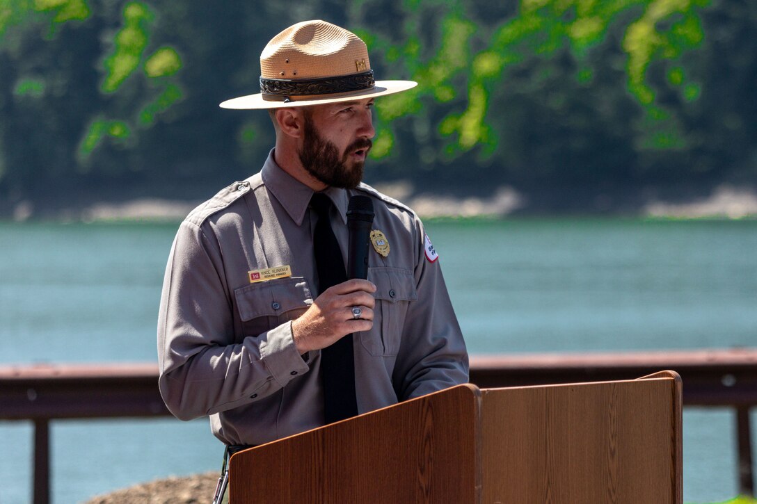 Vince Klinkner, the supervisory natural resource specialist at Youghiogheny River Lake, speaks during the time capsule dedication ceremony at Youghiogheny River Lake’s 75th celebration in Confluence, Pennsylvania on Aug. 19, 2023. Lake staff dedicated two time capsules were dedicated during the ceremony. One capsule held public messages, and another was for facility staff to include keepsakes such as a maintenance uniform shirt, a staff photo, name pins, and notes to future counterparts. Future lake staff will open the time capsules at the lake’s centennial celebration in 2048.