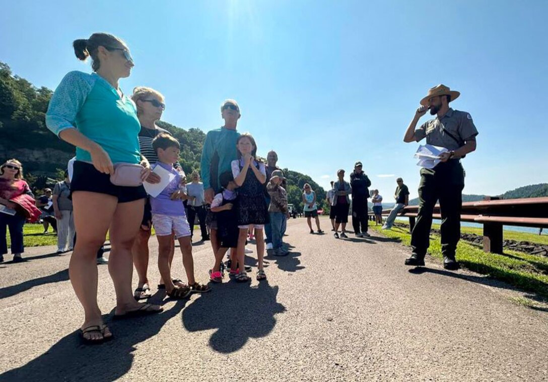 Summer Park Ranger Galen Scheufler leads a dam tour at Youghiogheny River Lake’s 75th anniversary celebration in Confluence, Pennsylvania on Aug. 19, 2023. The tour educated event attendees about general dam operations, the dam’s construction timeline and history, and allowed attendees to tour the dam’s control tower.