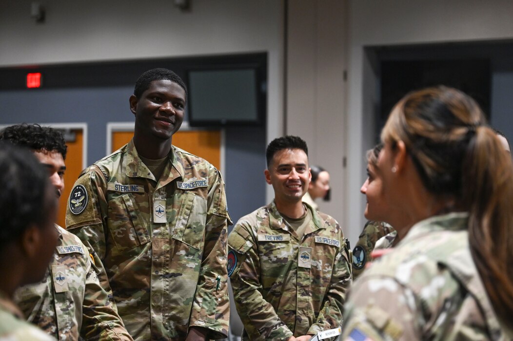 U.S. Space Force Spc. 2 Demicheal Sterling and Spc. 3 Daniel Trevino converse with attendees about the future of their Space Force careers before the Space Intelligence Fundamentals graduation at the Powell Event Center, Goodfellow Air Force Base, Texas, Aug. 22, 2023. Guardians who completed the course graduated with an understanding of the technically challenging operations of the space domain, unique aspects of the United States intelligence community, and how to use their training to combat adversaries. (U.S. Air Force photo by Airman 1st Class Madison Collier)
