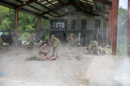 Airmen from the 138th Medical Group participate in a simulated combat environment as part of their final test in completing Tactical Combat Casualty Care Tier 2 in Perry, Fla., July 20, 2023. Smoke grenades and fake rounds were fired to simulate a deployed environment so Airmen could learn how to handle themselves and remain focused on the mission — caring for personnel and casualties.