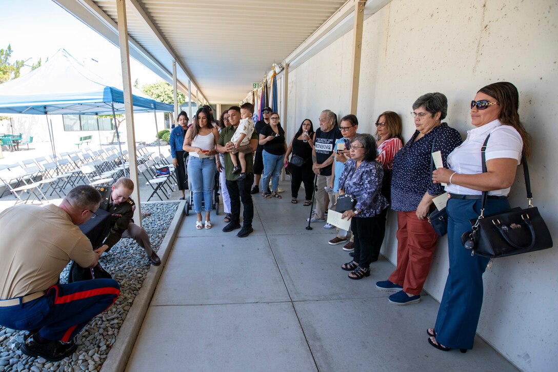 Marine Corps Col. Kevin Chunn, commander of DLA Distribution San Joaquin, California, and Chaplain, Army Capt. Terri Sykes unveil a monument during a ceremony dedicated to the families of the employees who lost their lives to the COVID pandemic on Aug. 18, 2023, at the DDJC installation. DLA photo by Julian Temblador.