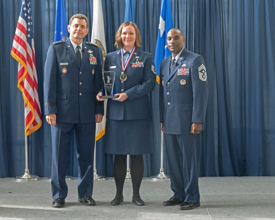 U.S. Air Force Tech. Sgt. Jessica Brazionis, center, information systems security manager, 217th Air Operations Group, 110th Wing, Michigan National Guard poses with Lt. Gen. Michael Loh, left, director, Air National Guard and Chief Master Sgt. Maurice Williams, command chief, ANG, after being recognized as the ANG’s Outstanding Non Commissioned Officer of the Year for the ANG during a ceremony at the  Air National Guard Readiness Center, Joint Base Andrews, Maryland, Aug. 24, 2023.