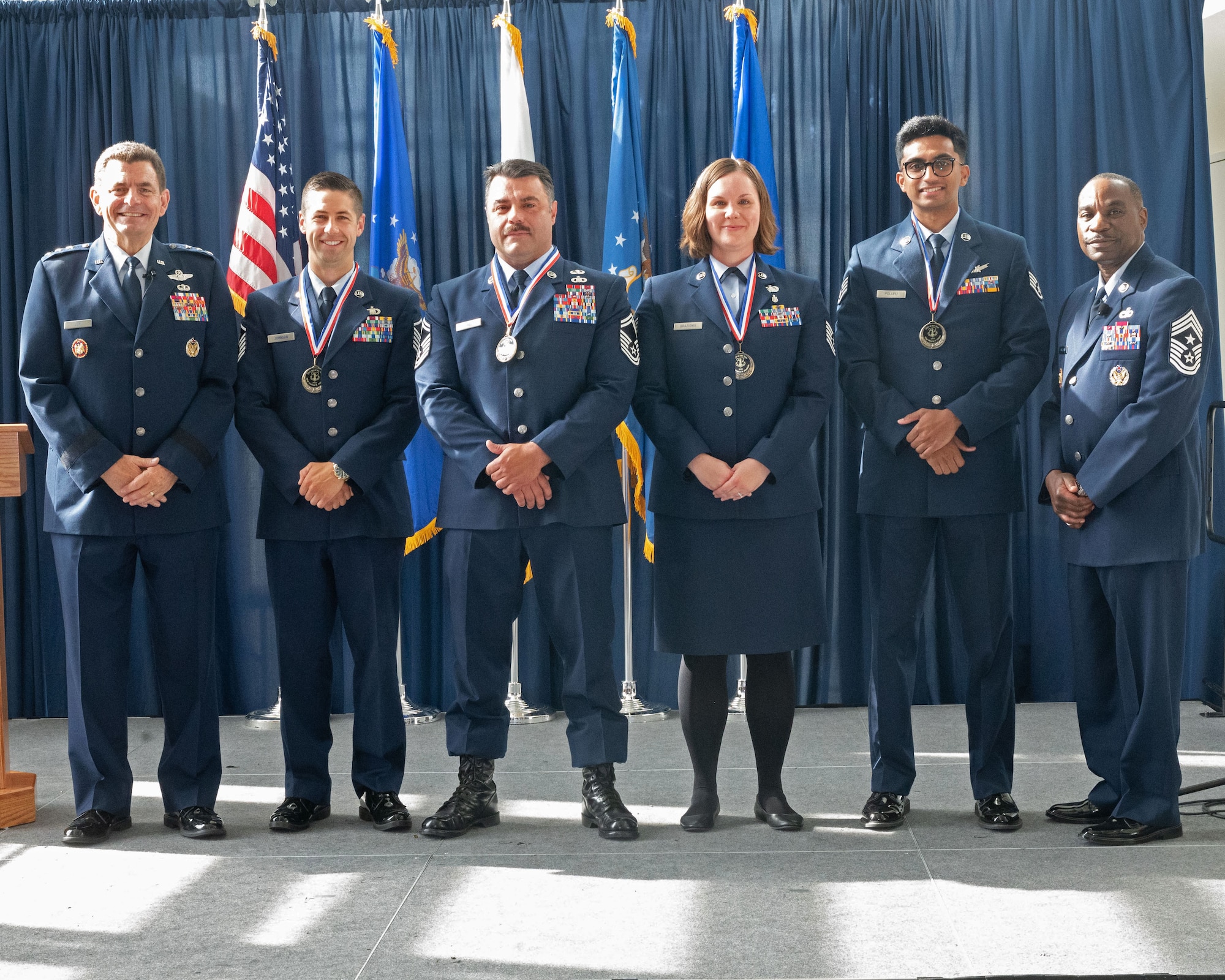 U.S. Air Force Lt. Gen. Michael Loh, left, director, Air National Guard and Chief Master Sgt. Maurice Williams, right, command chief, ANG, pose with the ANG’s 2023 Outstanding Airmen of the Year at the Air National Guard Readiness Center, Joint Base Andrews, Maryland, Aug. 24, 2023.