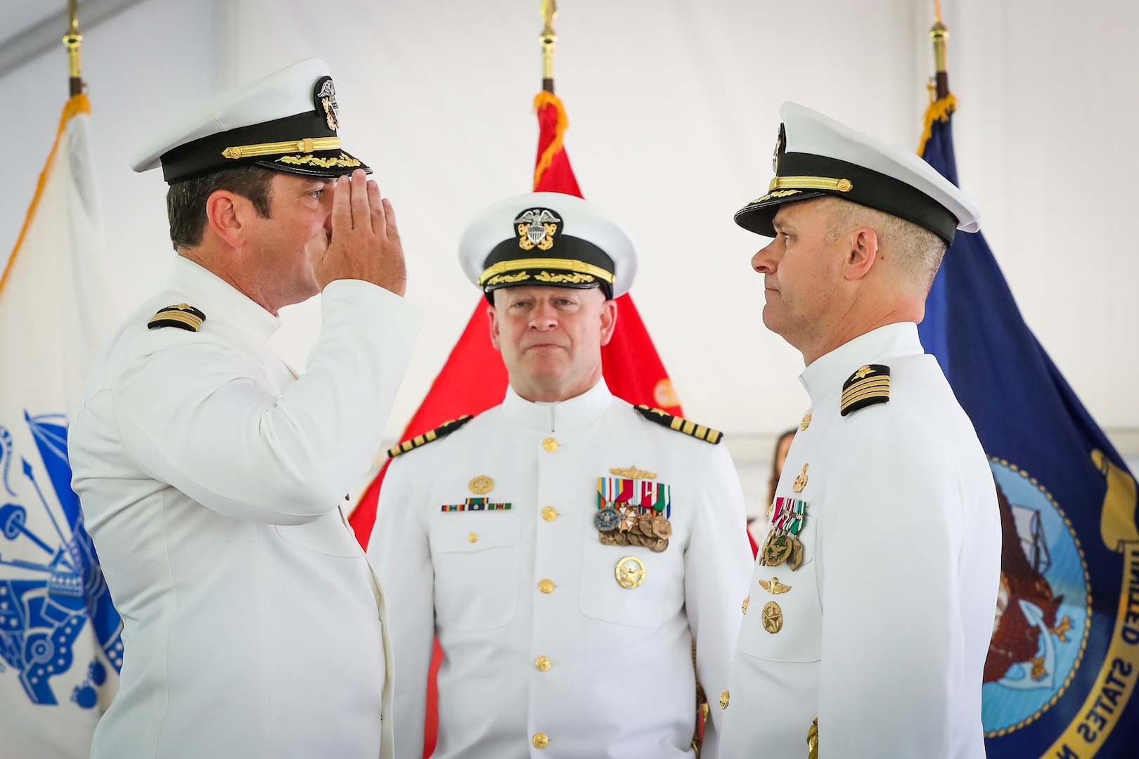 Rear Adm. Bradley Andros, commander of the Navy Expeditionary Combat Command (center), presides over the change of command ceremony in which Capt. Stephen Duba (left) relieved Capt. Eric Correll as commanding officer of Naval Surface Warfare Center Indian Head Division at Naval Support Facility Indian Head, Md., Aug. 25.