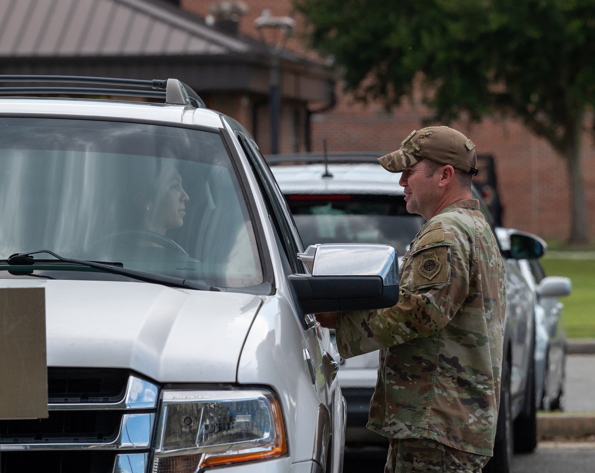 U.S. Air Force Col. Paul Sheets, 23rd Wing commander, brings food out to a military spouse during the Hearts Apart dinner at Moody Air Force Base, Georgia, Aug. 17, 2023. Events like these allow attendees to build friendships and help ease the stress and demands on families during deployment. (U.S. Air Force photo by Airman 1st Class Leonid Soubbotine)