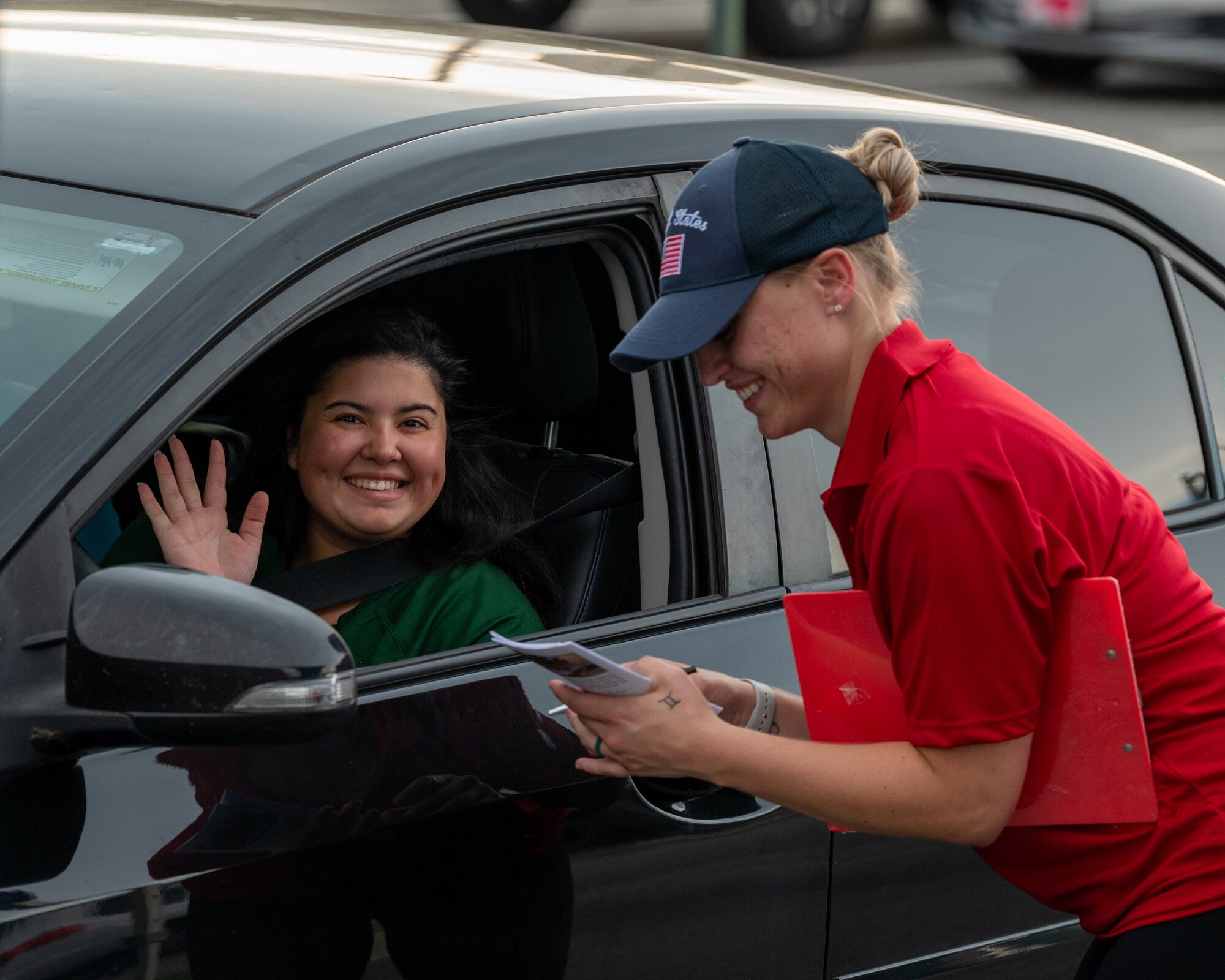 A volunteer receives an order from a military spouse during the Hearts Apart dinner at Moody Air Force Base, Georgia, Aug. 17, 2023. Events like these allow attendees to build friendships and help ease the stress and demands on families during deployment. (U.S. Air Force photo by Airman 1st Class Leonid Soubbotine)