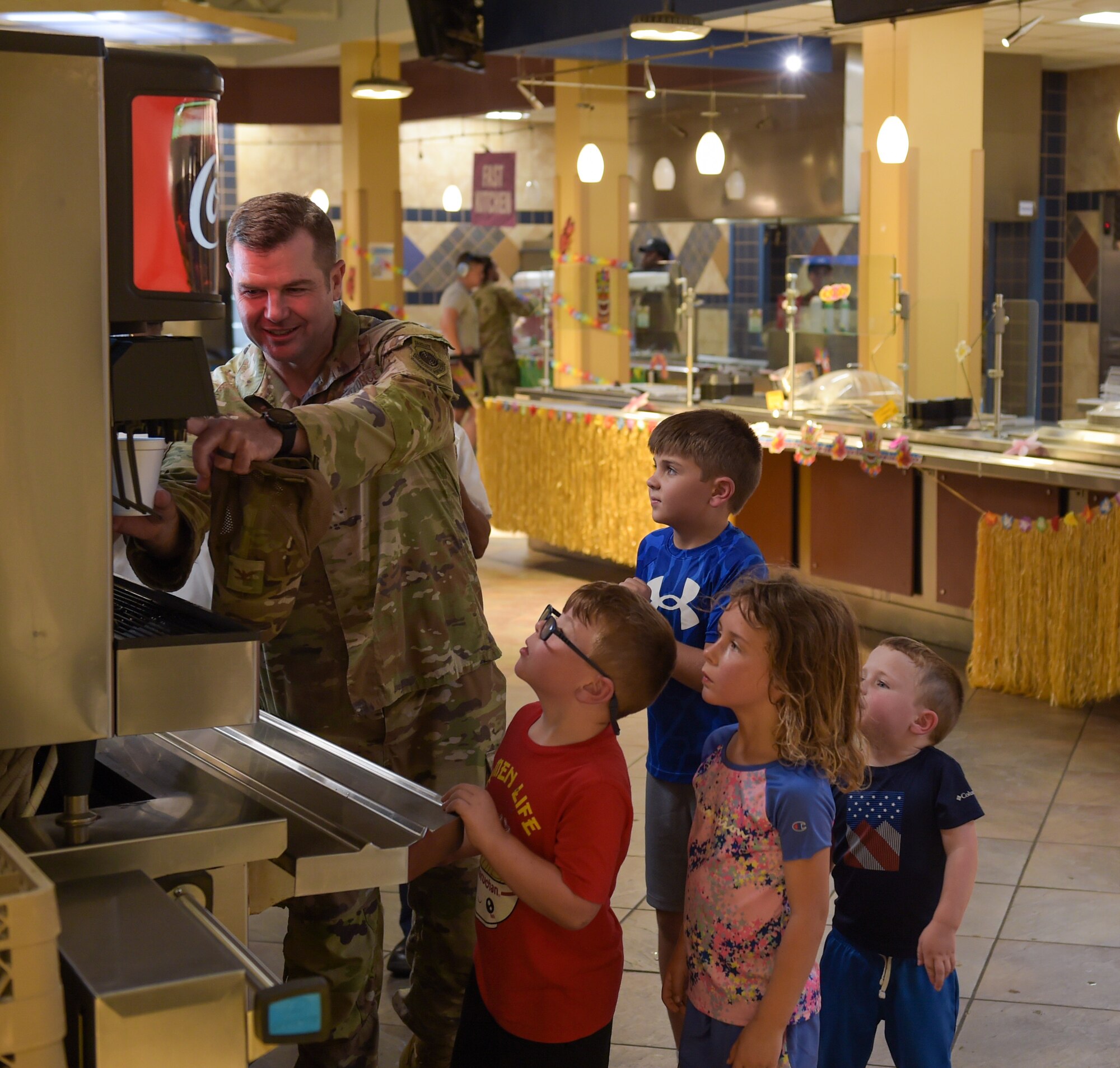 U.S. Air Force Col. Paul Sheets, 23rd Wing commander, fills up drinks for the kids during the Hearts Apart dinner at Moody Air Force Base, Georgia, Aug. 17, 2023. Events like these allow attendees to build friendships and help ease the stress and demands on families during deployment. (U.S. Air Force photo by Airman 1st Class Leonid Soubbotine)