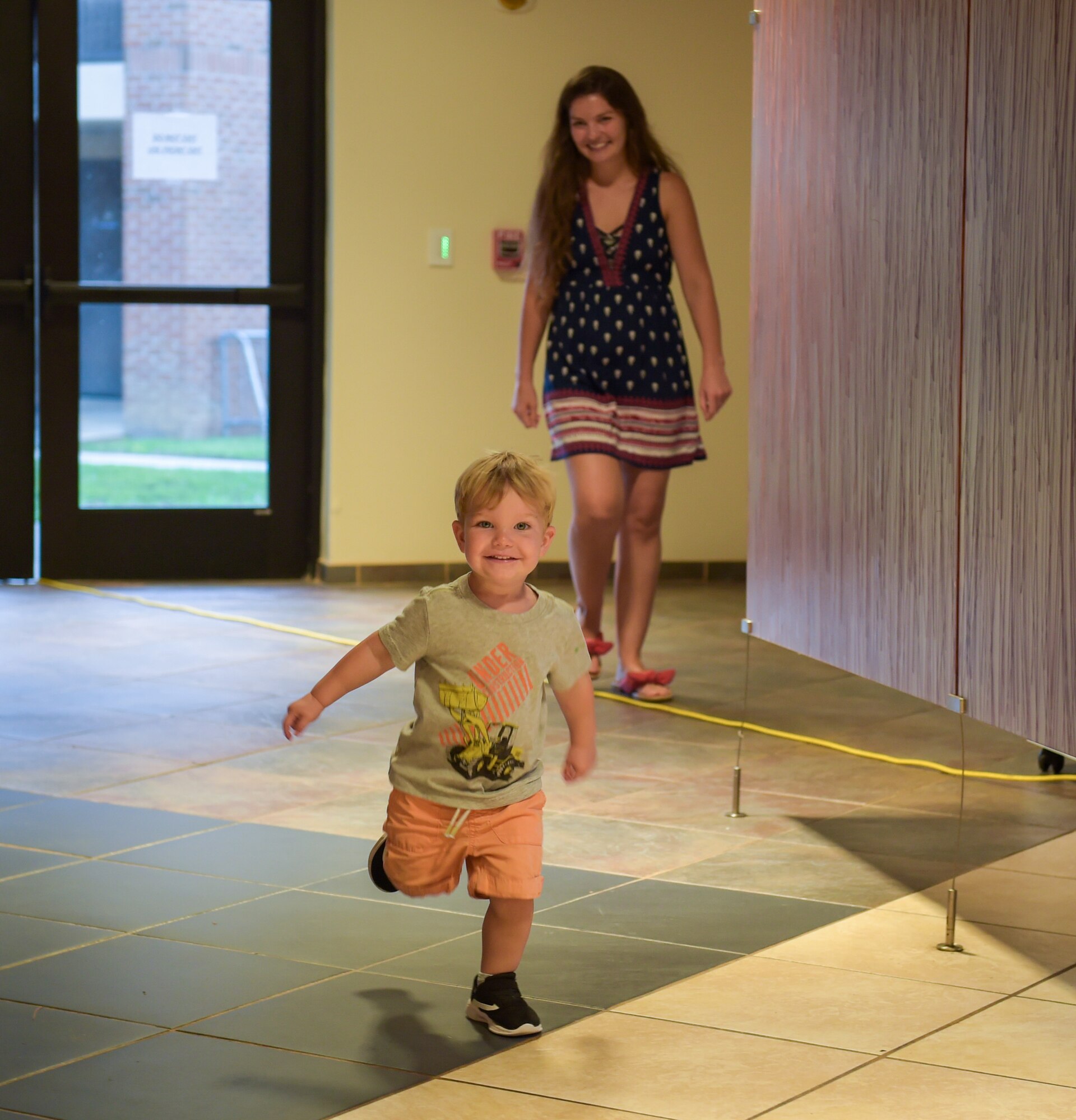 A child runs as his mom watches over during the Hearts Apart dinner at Moody Air Force Base, Georgia, Aug. 17, 2023. Events like these allow attendees to build friendships and help ease the stress and demands on families during deployment. (U.S. Air Force photo by Airman 1st Class Leonid Soubbotine)