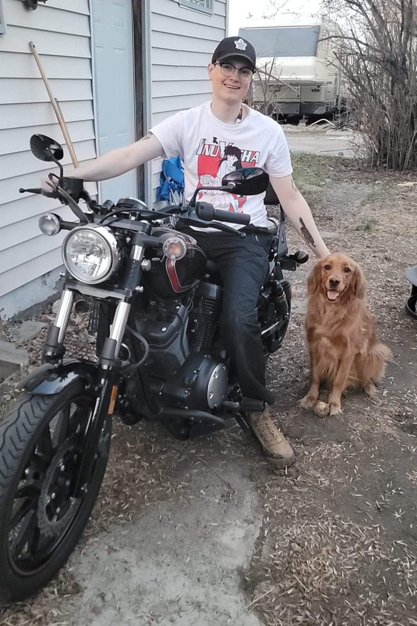 Senior Airman Caleb S. Kimmell, 5th Bomb Wing Public Affairs photojournalist, poses for a photo with his dog Cleo in Minot, North Dakota, May 20, 2023. Kimmell purchased the motorcycle and learned how to ride safely over the course of the summer.