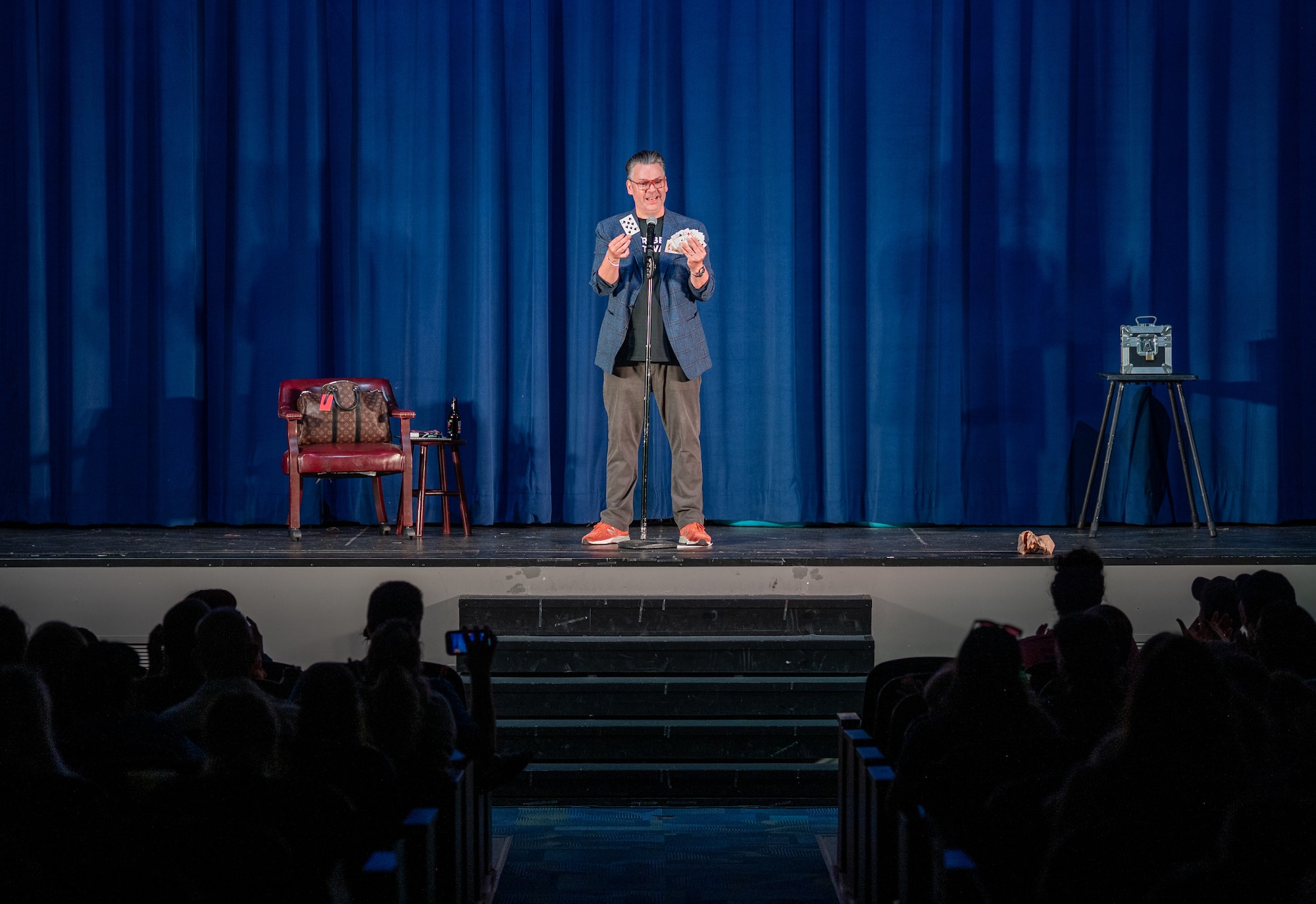 Derek Hughes, a comedian, performs a magic trick with a deck of cards during the Smash Up Comedy night at Moody Air Force Base, Georgia, Aug. 17, 2023. The Smash Up Comedy tour was an on-base family event which dazzled the audience with comedy, magic, and music. (U.S. Air Force photo by Airman 1st Class Leonid Soubbotine)