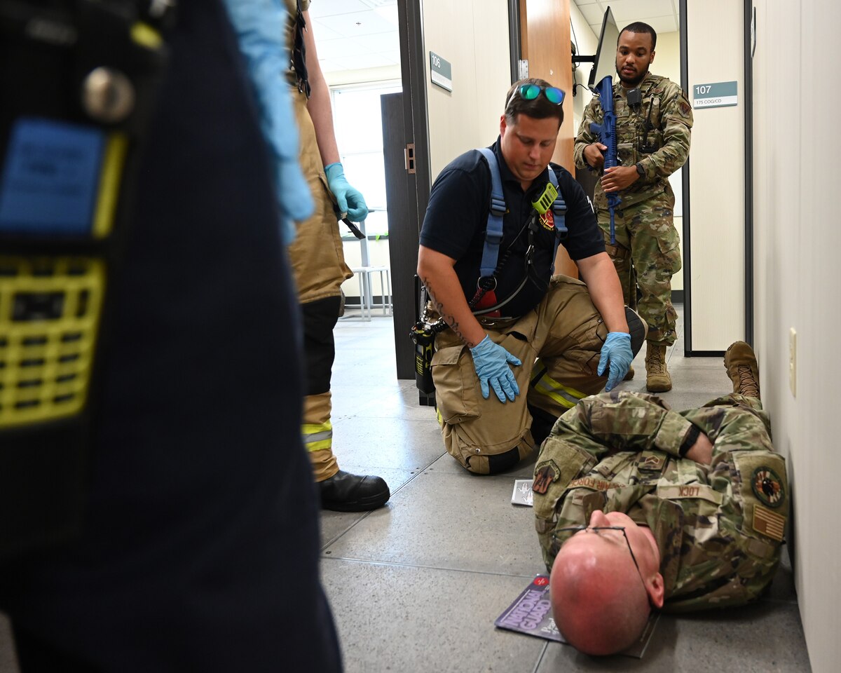 Members of the Maryland Air National Guard Fire Department treat a simulated patient during an active shooter exercise at Martin State Air National Guard Base, Middle River, Md., Aug. 25, 2023.