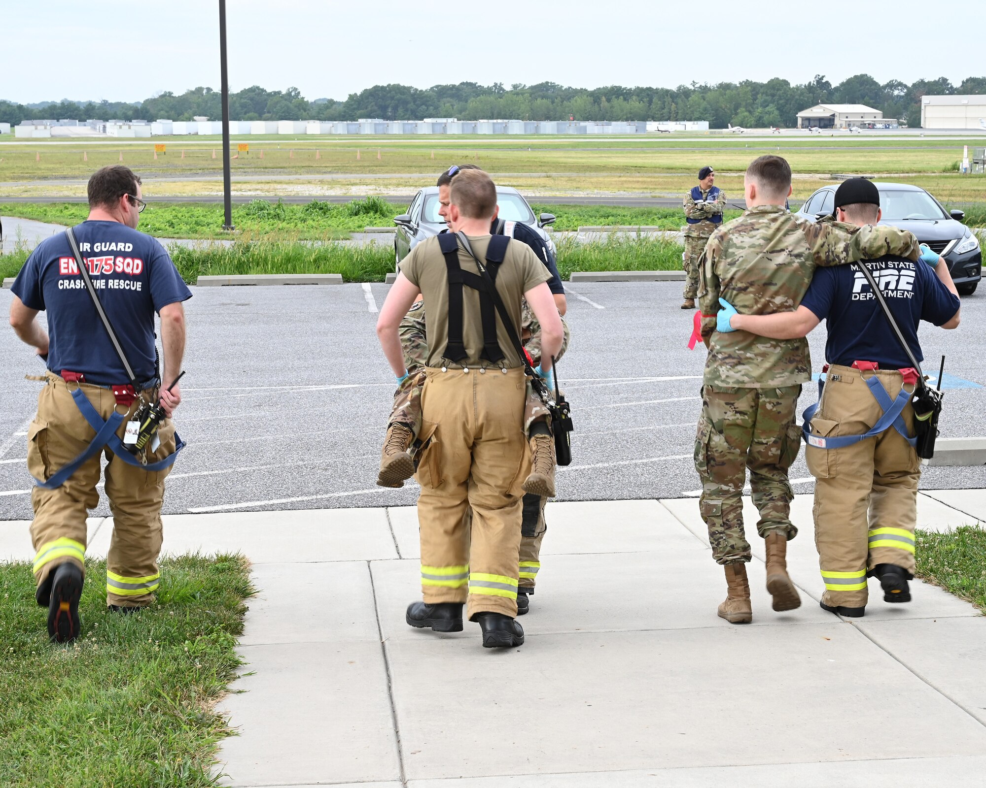 Members of the Maryland Air National Guard Fire Department transport simulated patients during an active shooter exercise at Martin State Air National Guard Base, Middle River, Md., Aug. 25, 2023.