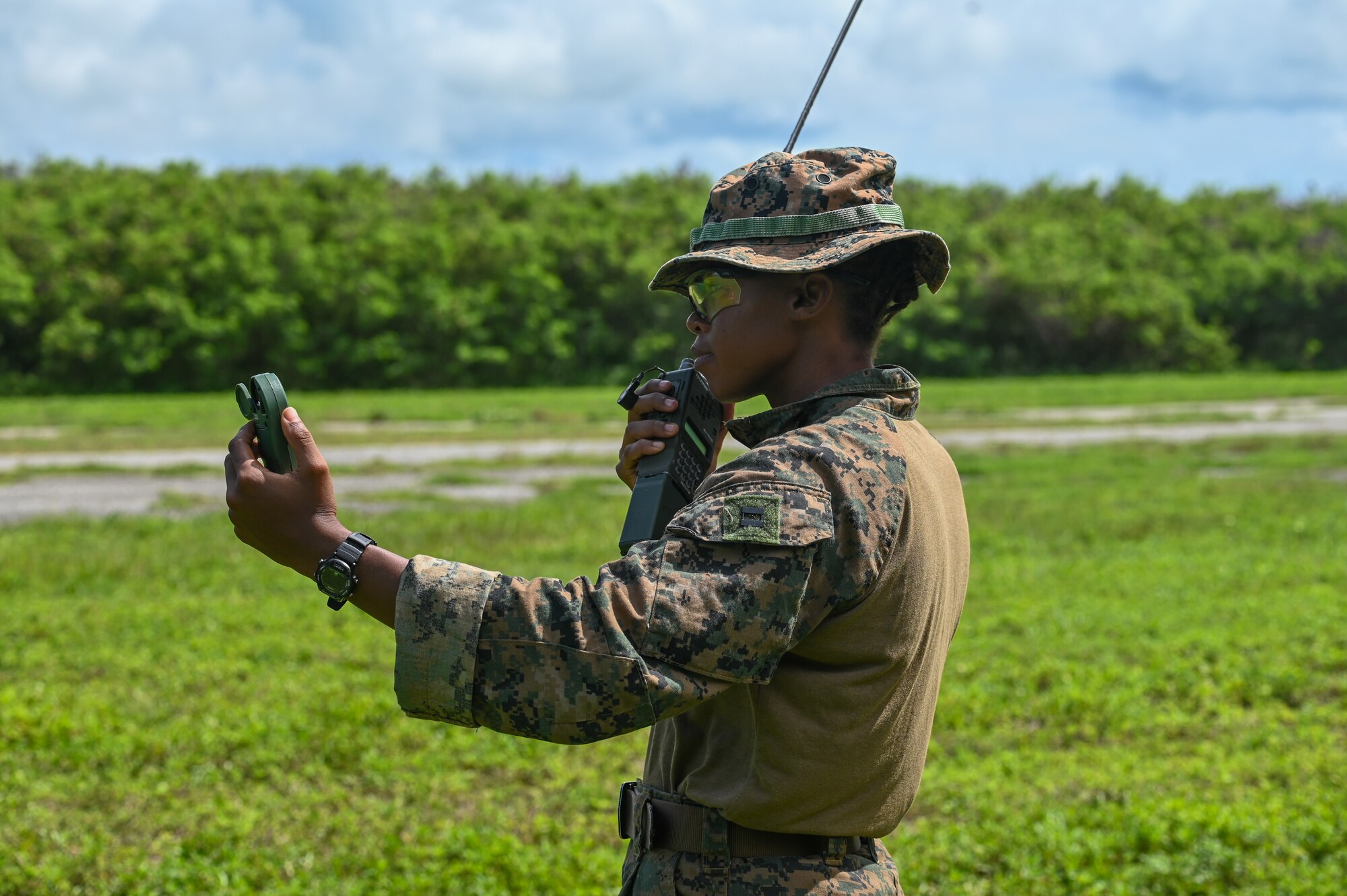 U.S. Marine Capt. Lecia Foster, exchange officer with the 36th Contingency Response Squadron, reads the wind speed and relays the message to incoming pilots on the island of Tinian, Aug. 17, 2023. Foster participated in a landing zone safety officer training course which consisted of learning airfield management functions, air traffic control functions and RAWS functions.(U.S. Air Force photo by Senior Airman Allison Martin)