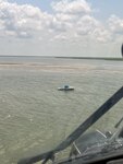 A Coast Guard Air Station New Orleans MH-60 Jayhawk helicopter aircrew spots a disabled 24-foot fishing vessel near Southwest Pass, Louisiana, August 24, 2023. The three persons aboard the vessel were later towed in to Cypress Cove Marina by a Coast Guard Station Venice 45-foot Response-Boat Medium boatcrew.