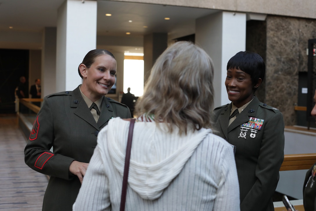 U.S. Marine Corps Gunnery Sgt. Shannell M. Styczynski, a logistics operations instructor, left, and Col. Marshalee E. Clarke, commanding officer of Marine Corps Combat Service Support Schools, socialize during an awards ceremony in Arlington, Virginia, Aug. 10, 2023. Styczynski, a native of Green Bay, Wisconsin, was recognized by the Marine Corps as the Formal School Instructor of the Year for 2022. (U.S. Marine Corps photo by Cpl. Tanner Pittard)