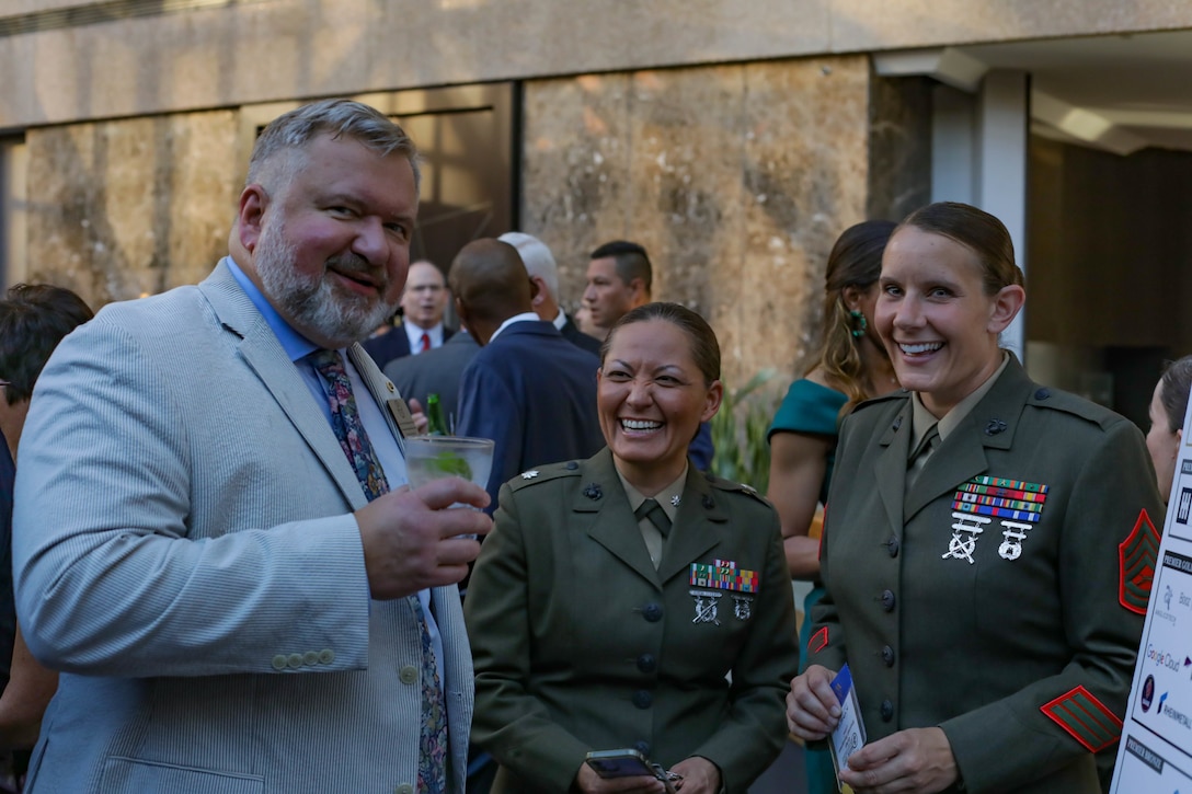 U.S. Marine Corps Gunnery Sgt. Shannell M. Styczynski, a logistics operations instructor, right, and Lt. Col. Amber G. Coleman, commanding officer of Logistics Operations School, socialize during an awards ceremony in Arlington, Virginia, Aug. 10, 2023. Styczynski, a native of Green Bay, Wisconsin, was recognized by the Marine Corps as the Formal School Instructor of the Year for 2022. (U.S. Marine Corps photo by Cpl. Tanner Pittard)