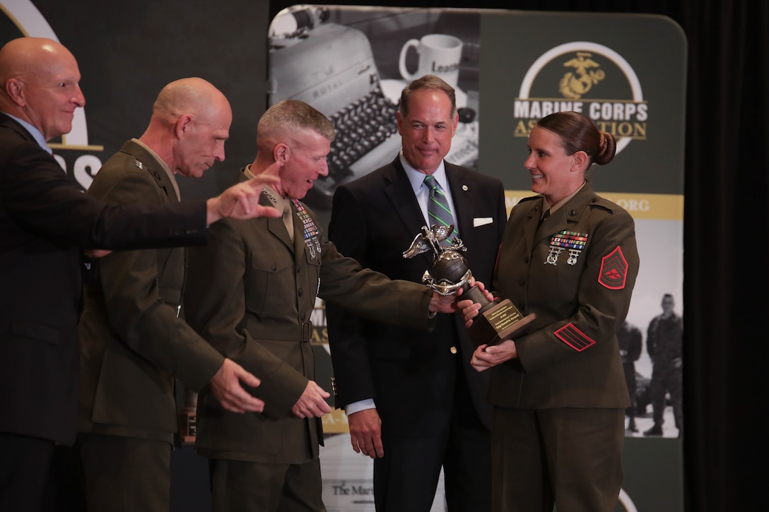 U.S. Marine Corps Gen. Eric M. Smith, 36th Assistant Commandant of the Marines Corps, presents an award to Gunnery Sgt. Shannell M. Styczynski, a logistics operations instructor, during an awards ceremony in Arlington, Virginia, Aug. 10, 2023. Styczynski, a native of Green Bay, Wisconsin, was recognized by the Marine Corps as the Formal School Instructor of the Year for 2022. (U.S. Marine Corps photo by Cpl. Tanner Pittard)