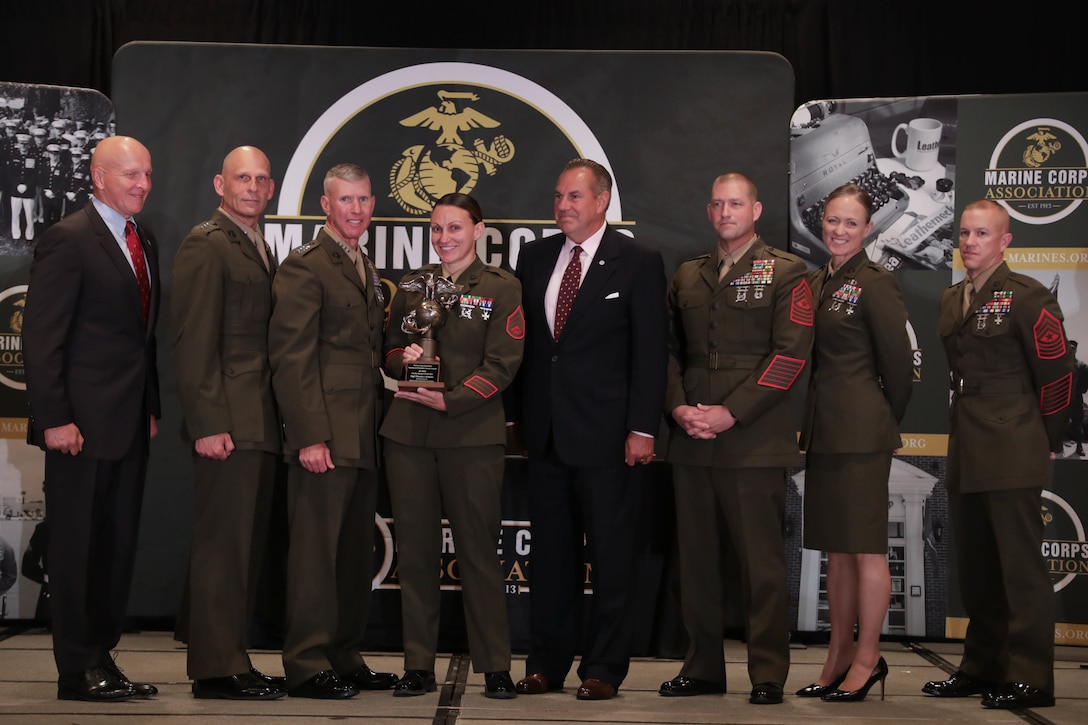 U.S. Marine Corps Staff Sgt. Victoria J. Graham, a faculty advisor, is honored during an awards ceremony in Arlington, Virginia, Aug. 10, 2023. Graham, a native of Waterloo, Michigan, was recognized by the Marine Corps as the Faculty Advisor of the Year for 2022. (U.S. Marine Corps photo by Cpl. Tanner Pittard)