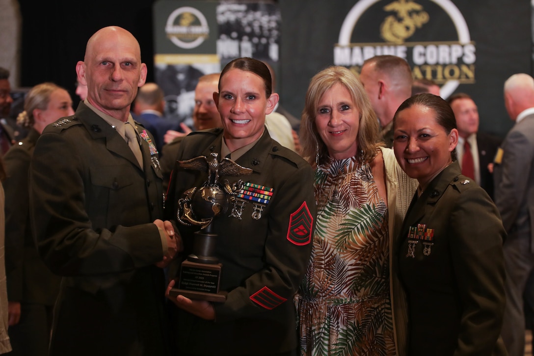 U.S. Marine Corps Lt. Gen. Kevin M. Iiams, commanding general of Training and Education Command, congratulates Gunnery Sgt. Shannell M. Styczynski, during an awards ceremony in Arlington, Virginia, Aug. 10, 2023. Styczynski, a native of Green Bay, Wisconsin, was recognized by the Marine Corps as the Formal School Instructor of the Year for 2022. (U.S. Marine Corps photo by Cpl. Tanner Pittard)