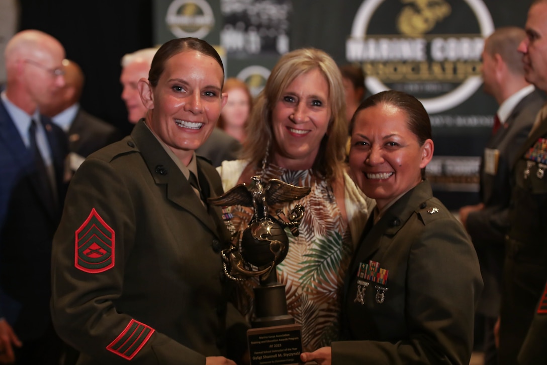 U.S. Marine Corps Lt Col Amber G. Coleman, commanding officer of Logistics Operations School, right, congratulates Gunnery Sgt. Shannell M. Styczynski, a logistics operations instructor, left, during an awards ceremony in Arlington, Virginia, Aug. 10, 2023. Styczynski, a native of Green Bay, Wisconsin, was recognized by the Marine Corps as the Formal School Instructor of the Year for 2022. (U.S. Marine Corps photo by Cpl. Tanner Pittard)