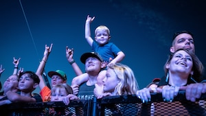 crowd cheers for band at rock concert