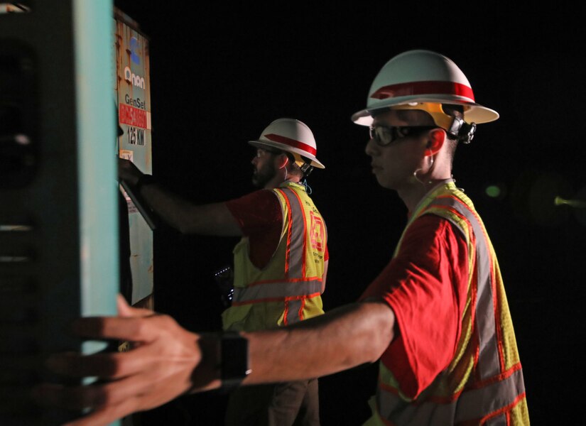 Kenny Kwan (foreground) and Jon Runnels (background), quality assurance representatives deployed with the U.S. Army Corps of Engineers Temporary Emergency Power Team, perform a quality assurance inspection of a generator at a water pump station on Maui, Aug 22.