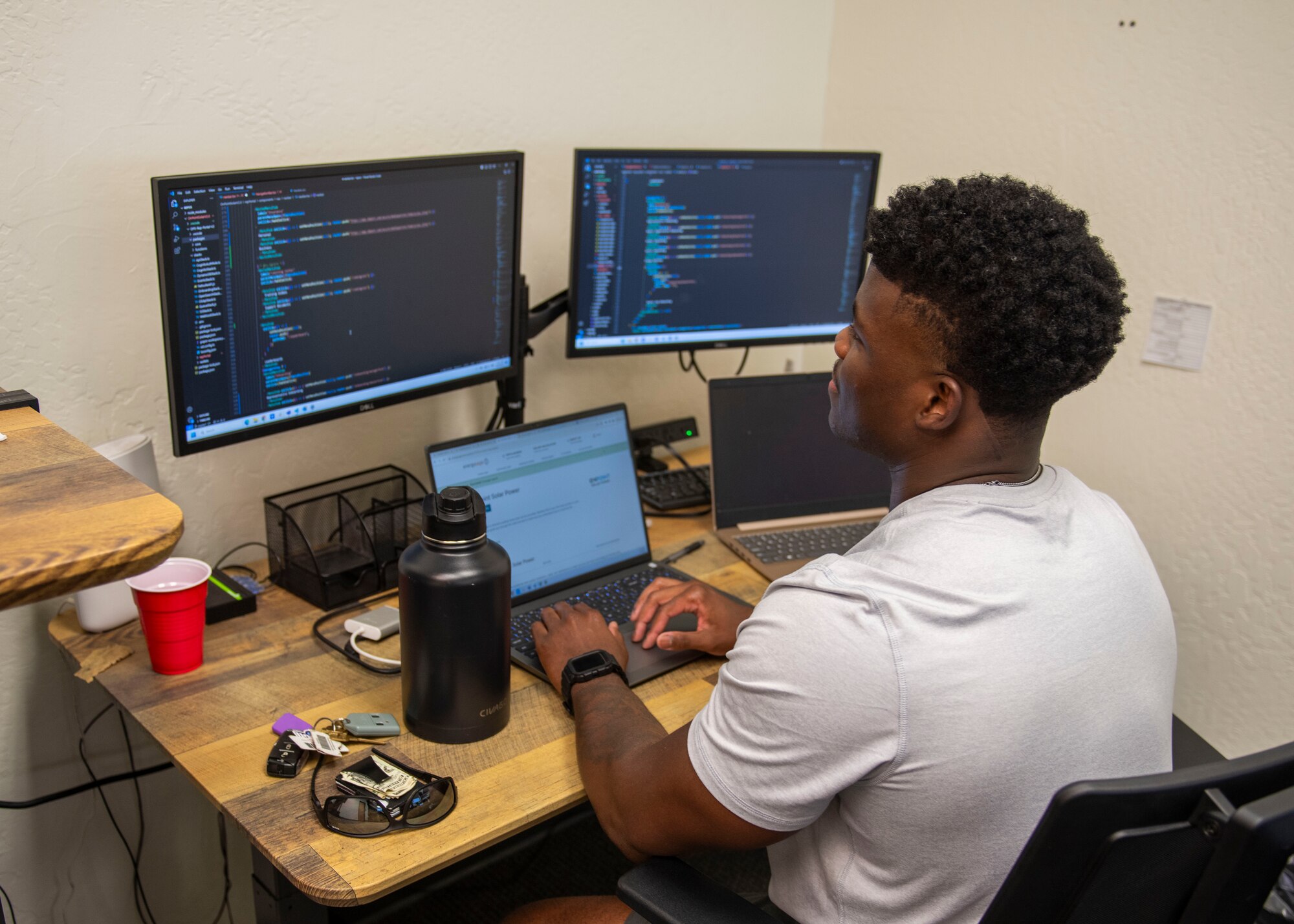 U.S. Air Force Staff Sgt. Donte Alexander, 372nd Training Squadron avionics instructor, reads through lines of code Aug. 23, 2023, at On Point Solar Power, Phoenix, Arizona.
