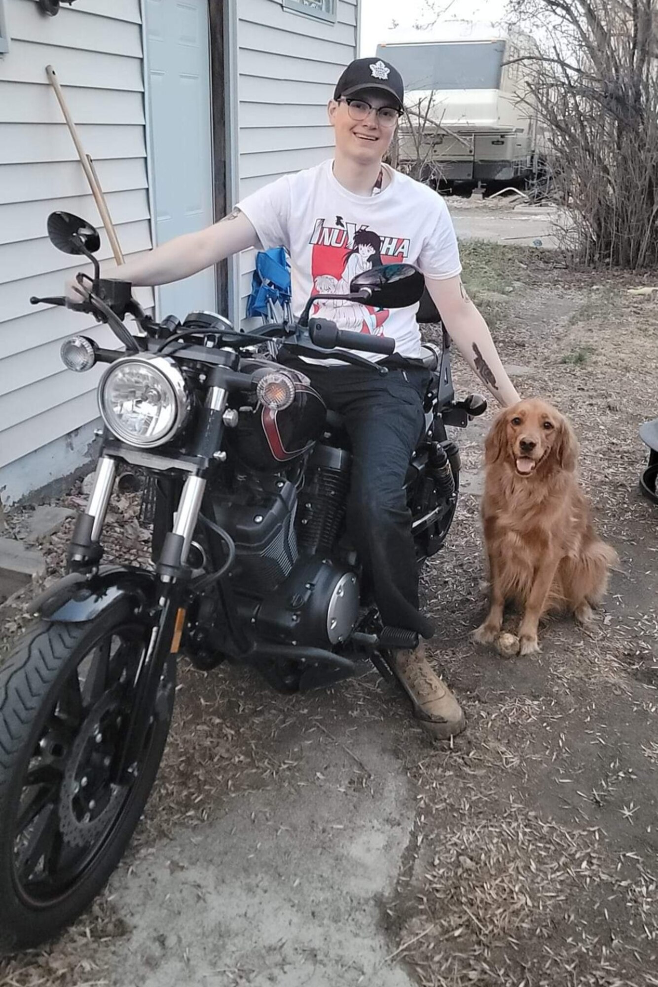 Senior Airman Caleb S. Kimmell, 5th Bomb Wing Public Affairs photojournalist, poses for a photo with his dog Cleo in Minot, North Dakota, May 20, 2023. Kimmell purchased the motorcycle and learned how to ride safely over the course of the summer.