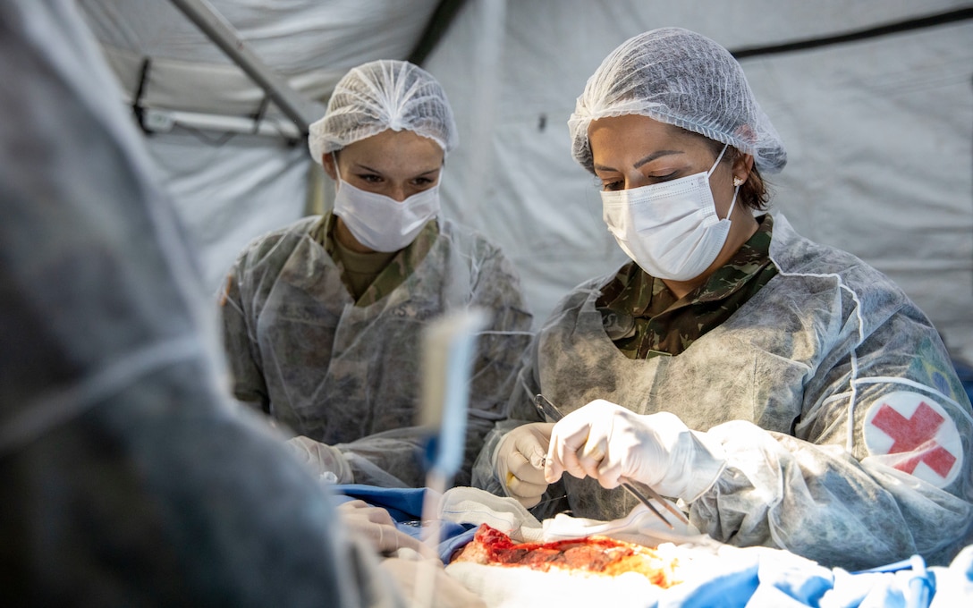 New York National Guard Sgt. Amanda Nelson, 466th Area Support Medical Company, works with Brazilian Army peers during Operation Paraná III in the State of Parana, Brazil, Aug. 15, 2023. The New York National Guard participated in the simulated humanitarian aid response exercise Aug. 12-19, 2023, as part of the Department of Defense National Guard Bureau State Partnership Program.