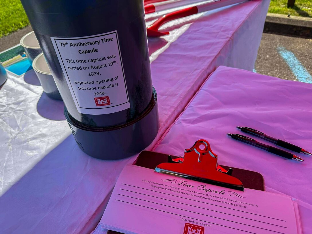 A time capsule and message slips are displayed during Youghiogheny River Lake’s 75th anniversary celebration in Confluence, Pennsylvania on Aug. 19, 2023. Lake staff dedicated two time capsules were dedicated during the ceremony. One capsule held public messages, and another was for facility staff to include keepsakes such as a maintenance uniform shirt, a staff photo, name pins, and notes to future counterparts. Future lake staff will open the time capsules at the lake’s centennial celebration in 2048.