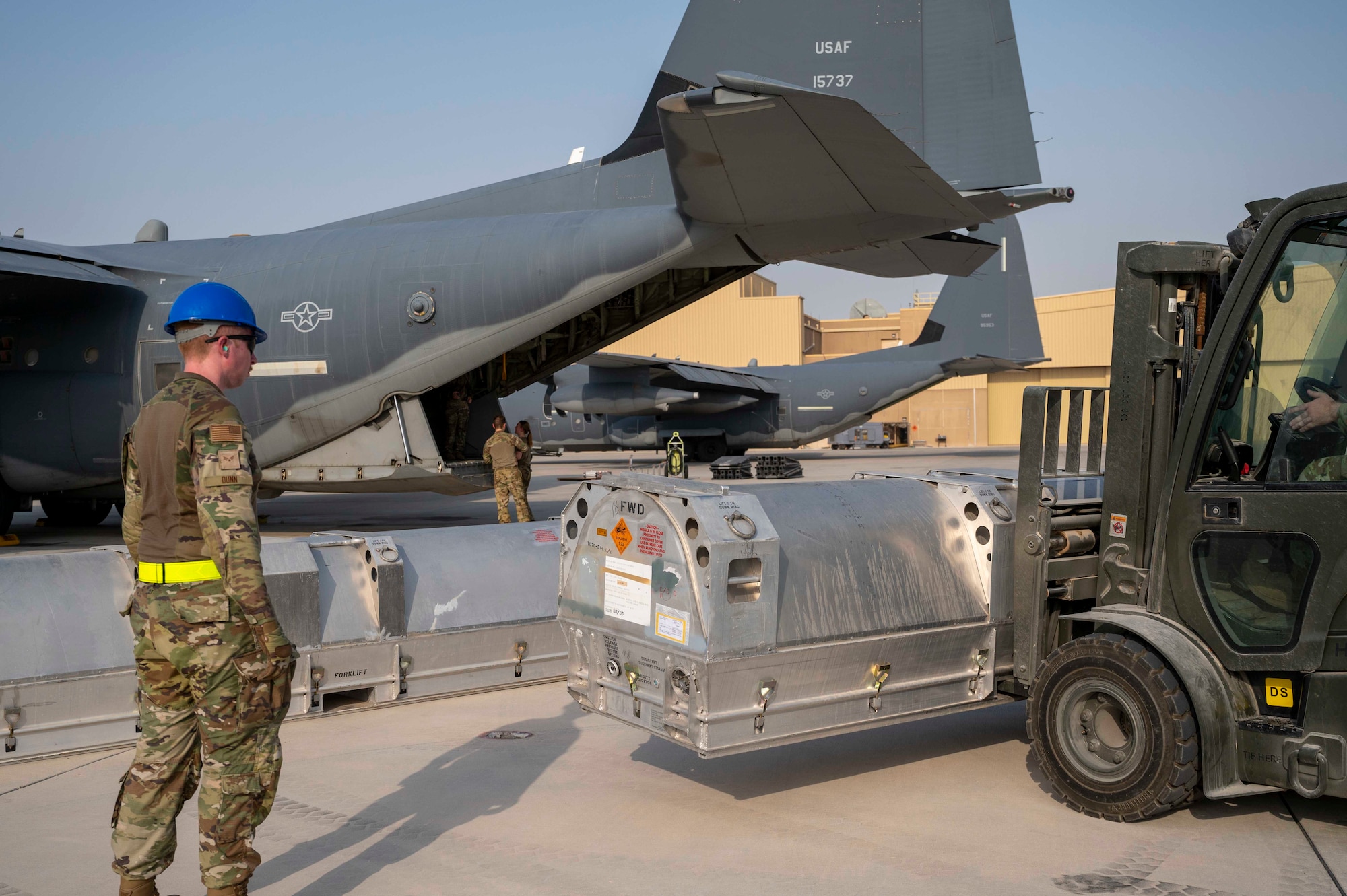 Members of the U.S. Air Force 6th Expeditionary Maintenance Squadron and the 6th Special Operations Tasking Unit stage Joint Air-to-Surface Standoff Missiles (JASSM) next to an MC-130J Commando II at Al Udeid Air Base, Qatar, Aug. 6, 2023. The Rapid Dragon palletized munitions system is capable of deploying long-range cruise missiles using standard airdrop procedures from cargo aircraft like the MC-130J operated by Air Force Special Operations Command. Rapid Dragon is a precision munitions capability for medium-sized or larger cargo aircraft that allows U.S. forces a flexible rapid response option. (U.S. Air Force photo by Staff Sgt. Frank Rohrig)
