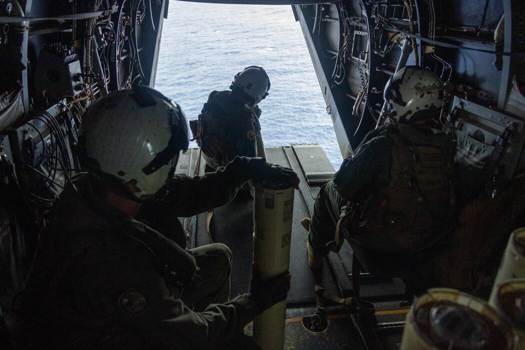 U.S. Marines with Marine Medium Tiltrotor Squadron 268 (VMM-268), Marine Aircraft Group 24, 1st Marine Aircraft Wing deploy sensor buoys from an MV-22 Osprey aircraft at Marine Corps Base Hawaii, Aug. 16, 2023. The sensor floats provide real-time data to help study hurricanes and increase naval knowledge of the ocean battlespace, including littoral areas which are crucial to expeditionary and amphibious operations. (U.S. Marine Corps photo by Lance Cpl. Clayton Baker)