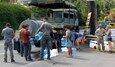 Hawaii Army National Guard Staff Sgt. Chris Lomboy, a motor transport operator assigned to Joint Task Force 50 (JTF-50) assists in providing water to people affected by the Maui fires in Kula, Maui, Aug. 26, 2023.