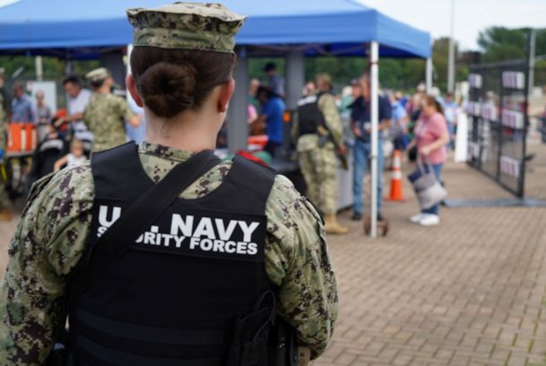 Navy security personnel unlock the gates and begin screening visitors to the annual Salute to Summer concert and fireworks event held at the installation Aug. 26, 2023.