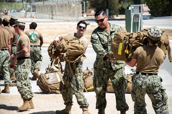 Seabees, assigned to Naval Mobile Construction Battalion 133 (NMCB 133), offload personnel gear on Camp Mitchell in Rota, Spain, August 24, 2023