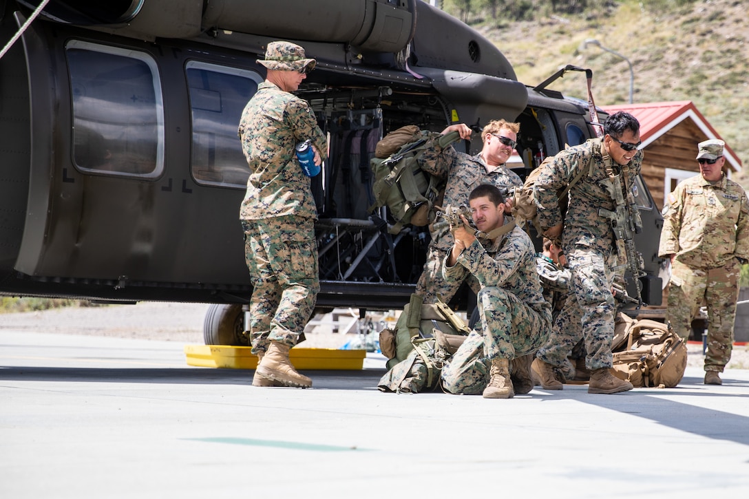 U.S. Marines assigned to the Camp Pendleton-based 1st Battalion, 111th Field Artillery, train on cold-loading procedures with the Marietta-based Alpha Company, 1st Battalion, 171st General Support Aviation Regiment, 78th Aviation Troop Command, Georgia Army National Guard, at the Marine Corps Mountain Warfare Training Center, Bridgeport, California, Aug. 25, 2023. Tough and realistic training in remote locations ensures the Georgia Army National Guard provides ready and relevant forces to our active-duty partners both in the state of Georgia, the United States, and across the globe. U.S. Army National Guard photo by Sgt. 1st Class Lannom Jr.