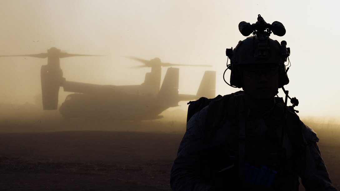 A U.S. Marine assigned to Reconnaissance Company, 15th Marine Expeditionary Unit, prepares to board an MV-22B Osprey attached to Marine Medium Tiltrotor Squadron (VMM) 165 (Reinforced), 15th MEU, before a raid during the ground interoperability exercise at Marine Corps Base Camp Pendleton, California, July 20, 2023. The ground interoperability training integrates Reconnaissance Company and supporting elements into a raid force to conduct land-based, specialized limited-scale raids in preparation for more complex amphibious and maritime operations. (U.S. Marine Corps photo by Cpl. Helms)