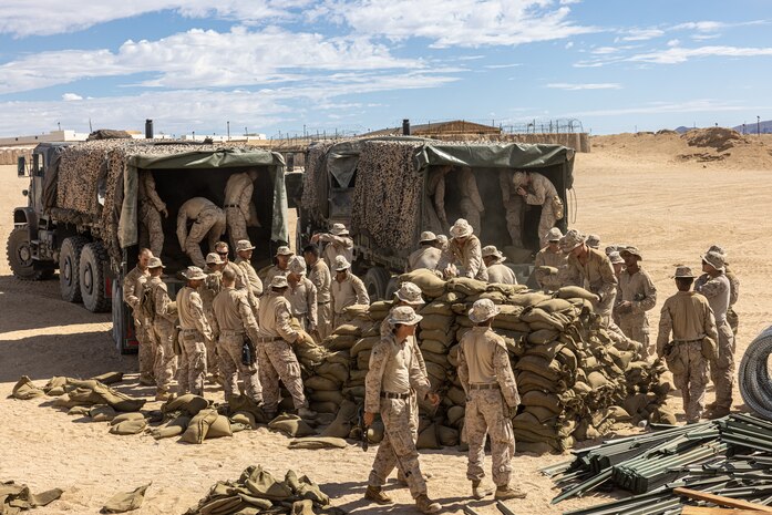 U.S. Marines with 3rd Battalion, 7th Marine Regiment, load sandbags onto a truck during Adversary Force Exercise 5-23 at Marine Corps Air-Ground Combat Center, Twentynine Palms, California, Aug. 9, 2023. AFX 5-23 tested the skills of Marines in seizing and maintaining a combat presence in urban environments by training in offensive and defensive tactics, conducing logistics in a contested environment, and utilizing mechanized infantry.