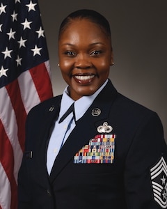 Woman in uniform smiles at camera