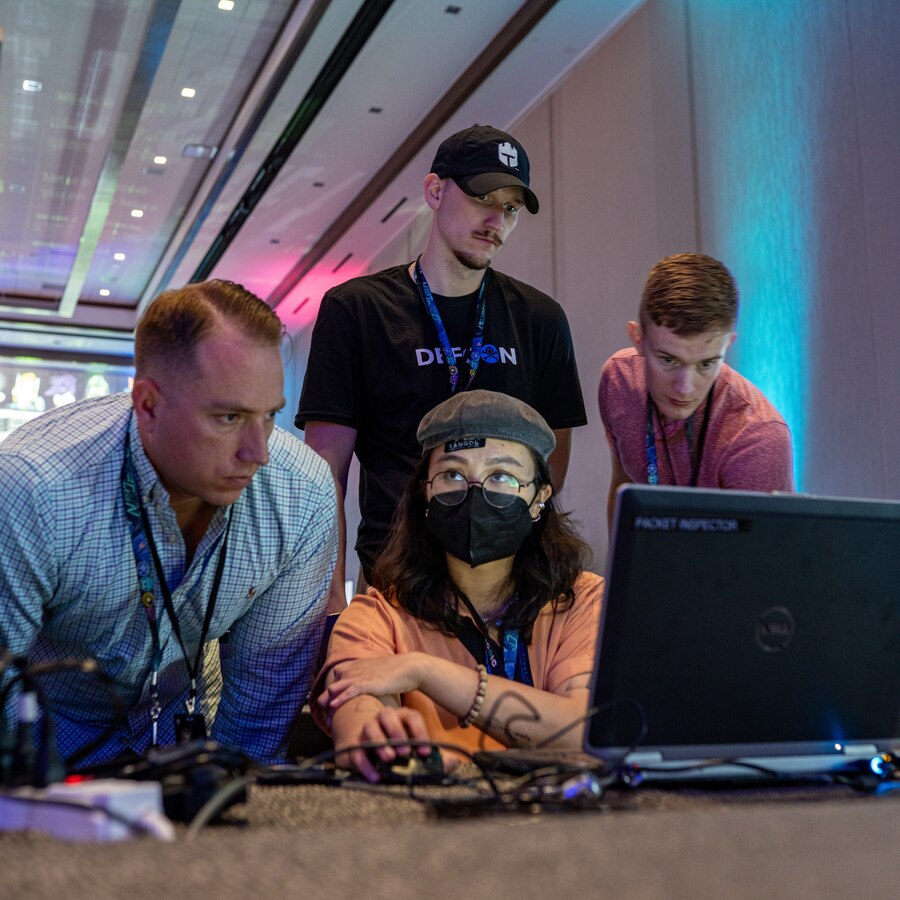 U.S. Marines with Defensive Cyberspace Operations, Force Headquarters Group, Marine Forces Reserve help a civilian with a computer network analysis hacking game called “Packet Inspector” at DEF CON31, Las Vegas, Nevada, Aug. 11, 2023. The Marines from FHG volunteered at the Caesars Forum in the “Packet Hacking Village”, a conference room turned computer hacking zone, to provide support to people from all skill levels about the importance internet safety procedures and practices. DEF CON helps identify opportunities to join and participate in think tanks, research organizations, interagency and industry sectors pertinent to DCO-IDM and Marine Forces Reserve. DCO-IDM and MARFORRES offer rare and valuable skills and experience found in a growing number of Reservists who work in cyber roles among hundreds of civilian employers. (U.S. Marine Corps photo by Cpl. Jonathan L. Gonzalez)
