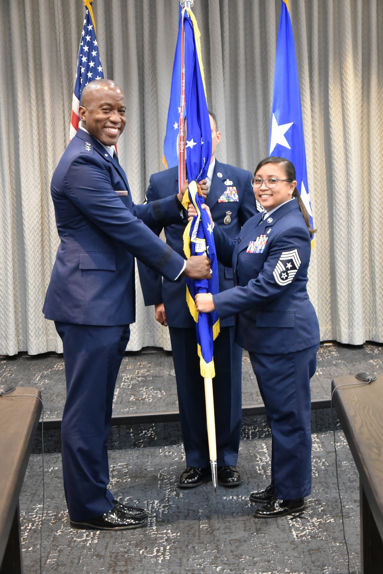 Lt. Gen. Hawkins passes the guidon to Command Chief Master Sgt. Maribeth O. Ferrer.