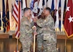 Maj. Gen. Robert L. Edmonson, right, commanding general of U.S. Army Communications-Electronics Command, passes the Army Medical Logistics Command’s unit colors to AMLC’s new commander, Col. Marc R. Welde, during an assumption of command ceremony Aug. 24 at Fort Detrick, Maryland. Also pictured is AMLC Sgt. Maj. Akram Shaheed.