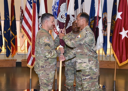 Maj. Gen. Robert L. Edmonson, right, commanding general of U.S. Army Communications-Electronics Command, passes the Army Medical Logistics Command’s unit colors to AMLC’s new commander, Col. Marc R. Welde, during an assumption of command ceremony Aug. 24 at Fort Detrick, Maryland. Also pictured is AMLC Sgt. Maj. Akram Shaheed.