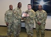 Col. Gary Cooper, center left, outgoing commander of Army Medical Logistics Command, presents the 2022 Army Exceptional Organization Safety Award for the battalion level to Lt. Col. Mark Sander, commander of the U.S. Army Medical Materiel Center-Korea, and Master Sgt. Willie Green, USAMMC-K senior enlisted leader. Alongside Cooper is AMLC Sgt. Maj. Akram Shaheed. It’s the first time USAMMC-K has earned the Army-wide safety honor.