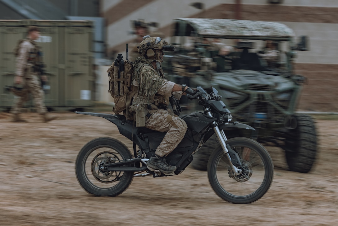A U.S. Marine assigned to Reconnaissance Company, 15th Marine Expeditionary Unit, holds security in a Polaris MRZR during a raid as part of the ground interoperability exercise at Marine Corps Base Camp Pendleton, California, July 21, 2023. The ground interoperability training integrates Reconnaissance Company and supporting elements into a raid force to conduct land-based, specialized limited-scale raids in preparation for more complex amphibious and maritime operations. (U.S. Marine Corps photo by Cpl. Helms)