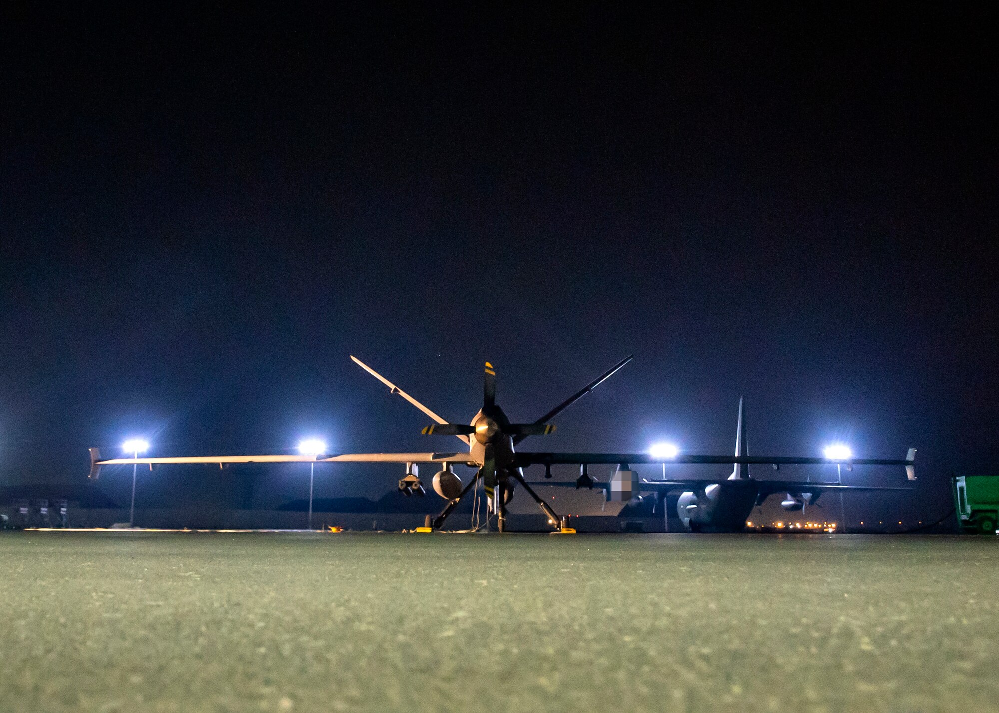 A U.S. Air Force MQ-9 aircraft assigned to the 46th Expeditionary Attack Squadron, prepares for an Operation Agile Spartan mission departing from Ali Al Salem Air Base, Kuwait, August 21, 2023. This MQ-9 and three others conducted the 386 AEW's first full air tasking order (ATO) cycle using satellite launch and recovery (SLR), providing crucial time-sensitive intelligence, surveillance and reconnaissance to leaders throughout the CENTCOM area of responsibility. (This photo has been altered for security purposes) (U.S. Air Force photo by Tech. Sgt. Isaac Garden)