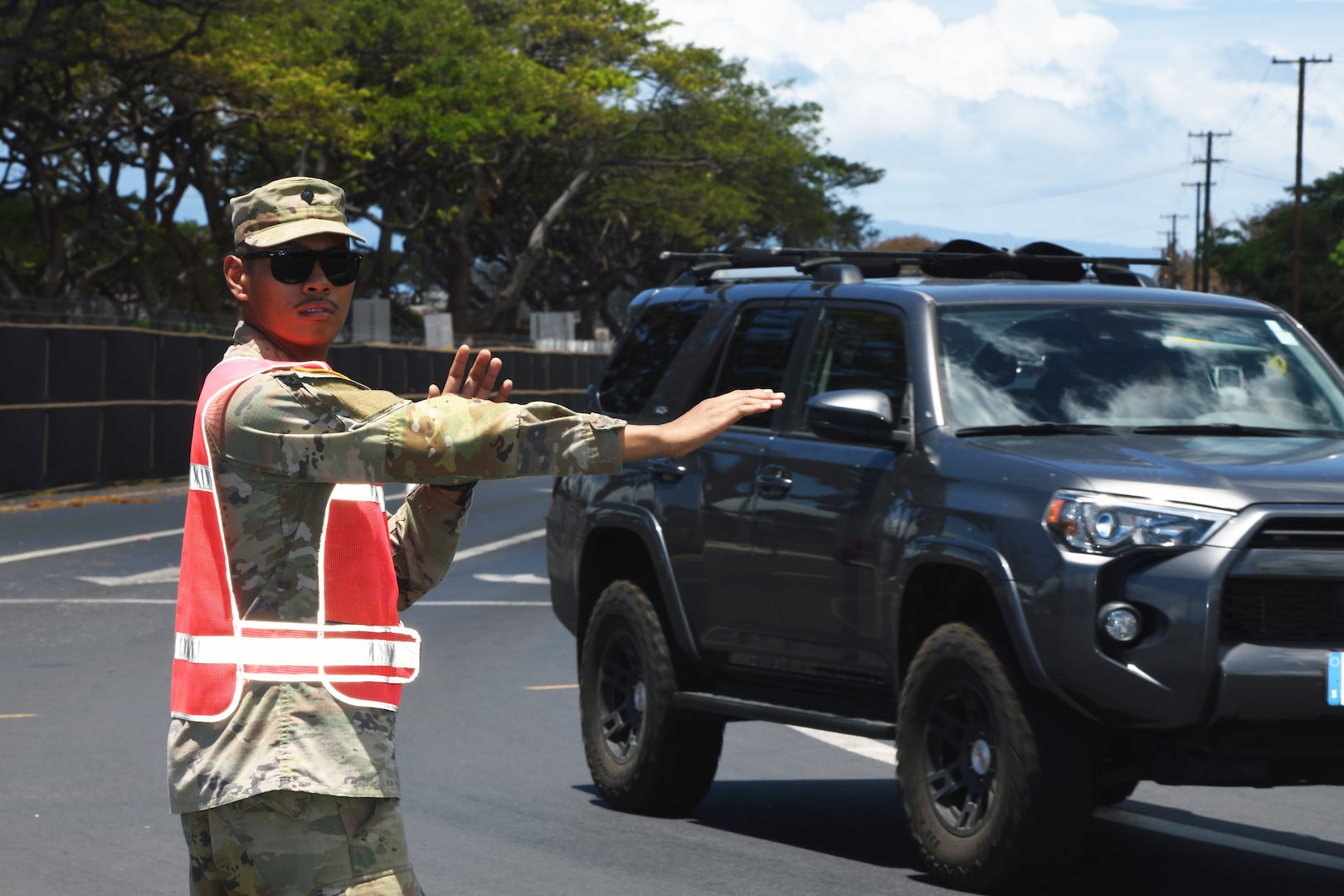 Spc. Joshua Torres, a fire control specialist with the Hawaii Army National Guard’s 1st Battalion, 487th Field Artillery Regiment, directs traffic as part of the National Guard’s response to the deadly Maui wildfires in Lahaina, Hawaii, Aug 25, 2023. The Defense Department and the U.S. Coast Guard are supporting the FEMA-led response to the deadliest wildfire in Hawaii’s history.