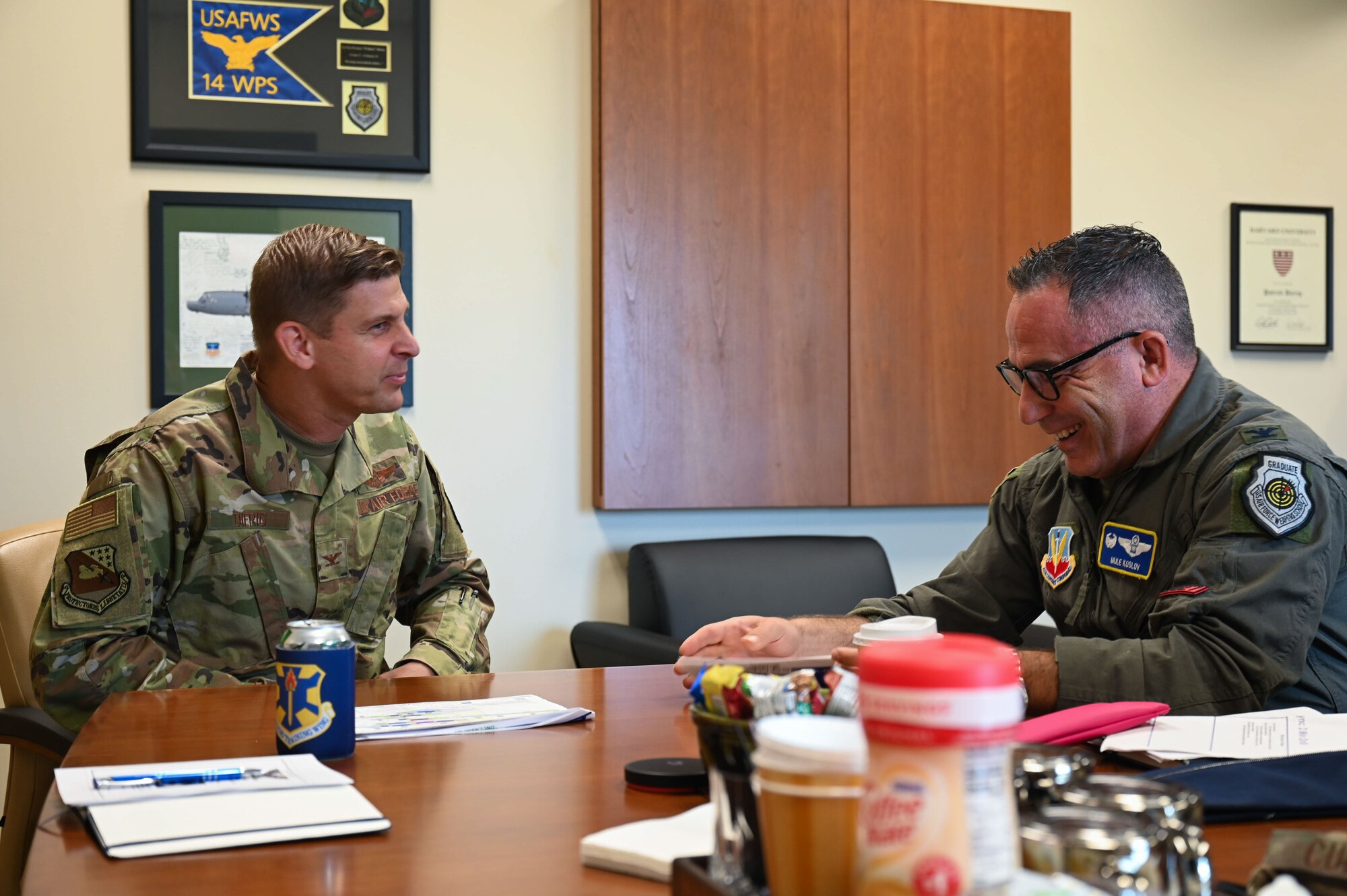 U.S. Air Force Col. Patrick Dierig, 479th Flying Training Group commander, left, talks with U.S. Air Force Col. Josh Koslov, 350th Spectrum Warfare Wing commander, right, about the curriculum of the 479th FTG at Naval Air Station Pensacola, Fla., Aug. 24, 2023. Koslov received a tour of the unit and talked with students, giving career advice and a brief on the 350th SWW. (U.S. Air Force photo by Capt. Benjamin Aronson)