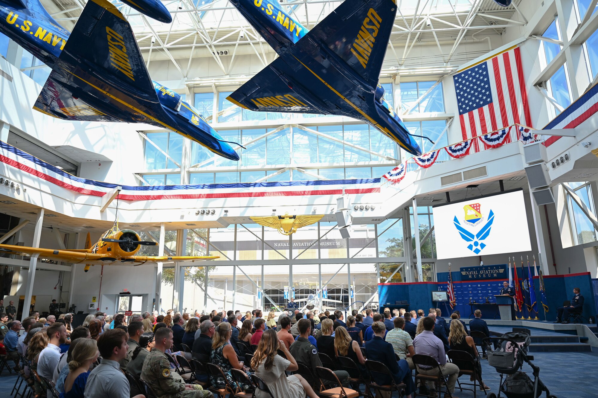 U.S. Air Force Col. Josh Koslov, 350th Spectrum Warfare Wing commander, gives the keynote address during the Undergraduate Combat Systems Officer Training graduation at the National Naval Aviation Museum, Naval Air Station Pensacola, Fla., Aug. 25, 2023. Koslov was invited as the keynote speaker during the graduation ceremony. (U.S. Air Force photo by Capt. Benjamin Aronson)